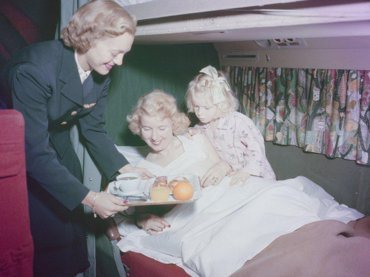 in-the-1950s-passengers-in-sleeper-cabins-on-a-dc-6-aircraft-were-served-an-in-flight-breakfast-in-bed